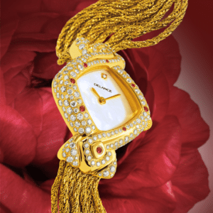 feminine watch - Mahalaxmi: Gold watch set with 235 diamonds and 6 rubies, white mother-of-pearl dial with a diamond index, gold-plated hands, gold cabochon with a ruby, gold cascade strap